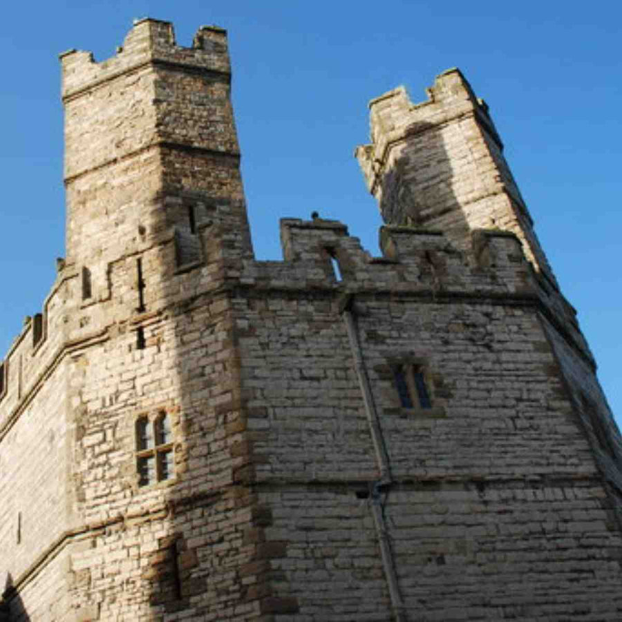 Caernarfon castle's Eagle tower set against a blue sky