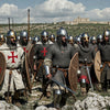 an army of Crusader knights in battle dress with a fortress in the background