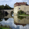 leeds castle and moat with a bridge to the gatehouse