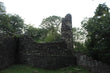 Ruined western tower and curtain wall of Ewloe Castle surrounded by woodland, October 2026