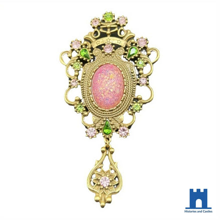 Baroque brooch in antique gold tone with pink iridescent oval cabochon, green and pink crystal setting and dangling openwork floral drop, 11.2cm