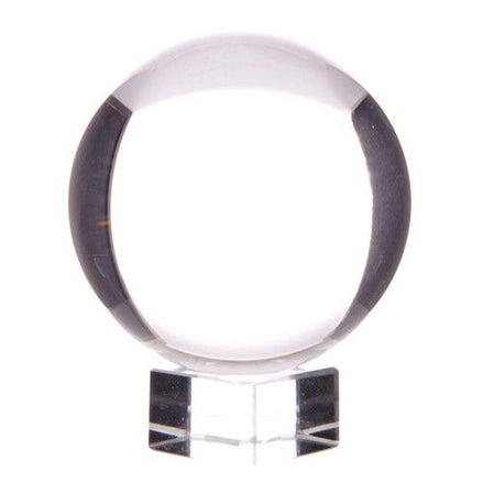 Clear crystal ball on a stand with a white background