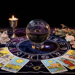 Crystal ball on a tarot table with tarot cards and candles
