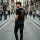 Man wearing a black t-shirt with a graphic design on a city street