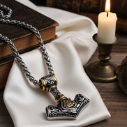 Viking-style necklace with hammer pendant on a white cloth with a candle in the background