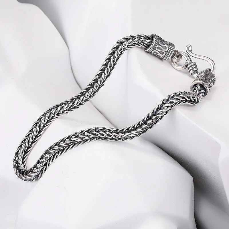 Silver braided necklace on a white mannequin