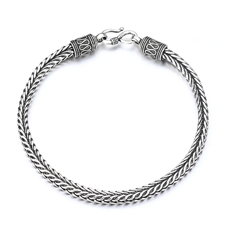 Silver braided bracelet on a white background