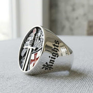Silver ring with 'Knights' engraving on a textured surface