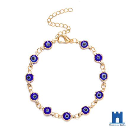 Turkish evil eye bracelet with 10 blue Nazar beads in gold tone bezels on adjustable gold tone chain with lobster clasp