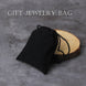 Black jewelry bag on a wooden block with 'Gift Jewelry Bag' text on a gray background
