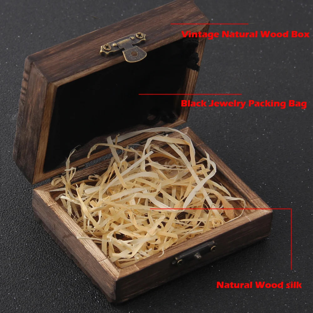 Wooden jewelry box with black interior and natural wood silk, on a dark background.