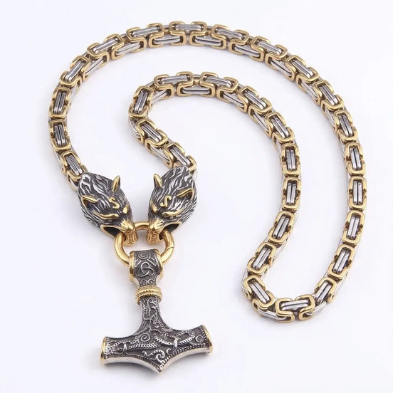 Stainless steel Mjolnir pendant with wolf head clasp on gold and silver byzantine chain on a white background