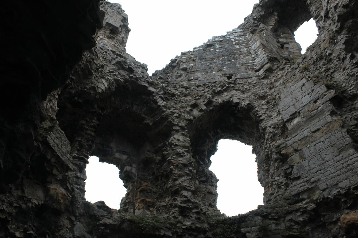 Looking up at the ruined arches and window openings inside the great gatehouse of Denbigh Castle, October 2026