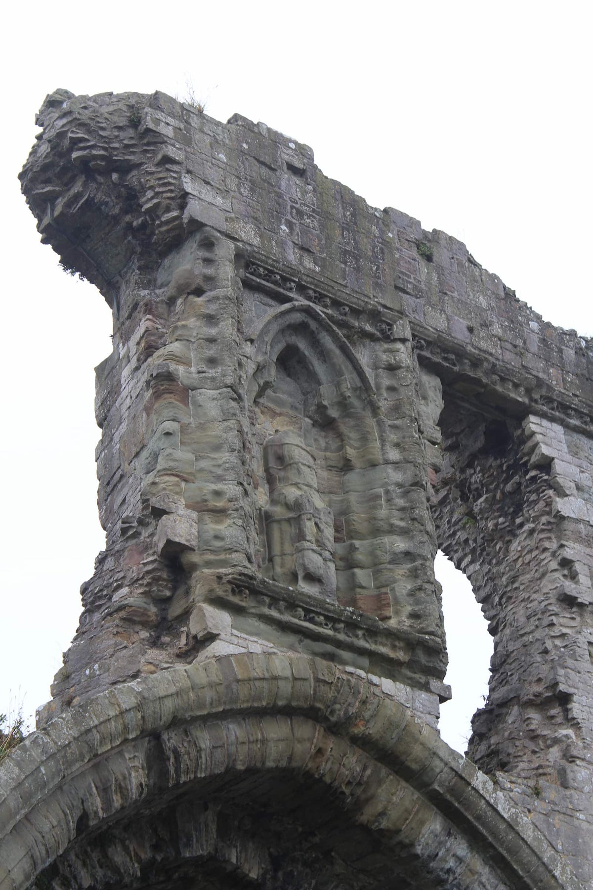 Close-up of the worn statue niche above the great gatehouse arch at Denbigh Castle, October 2026