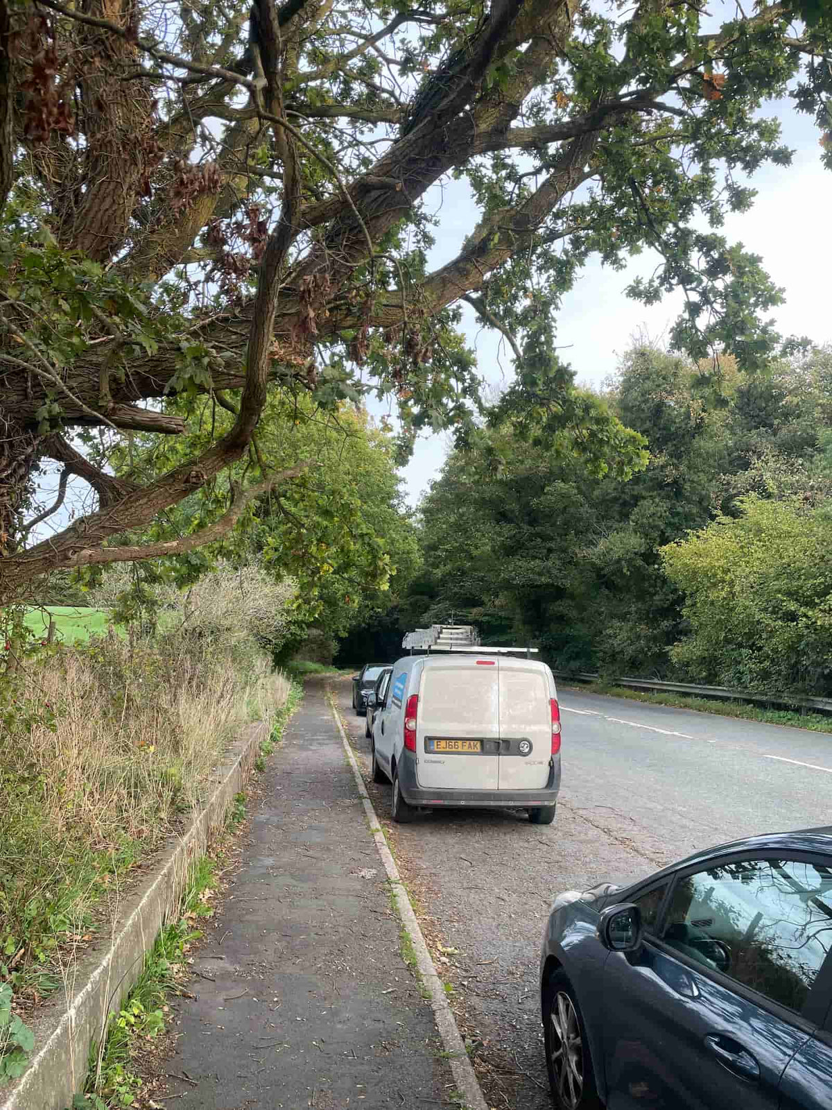 Roadside lay-by used for parking near Ewloe Castle, beside a busy road, October 2026