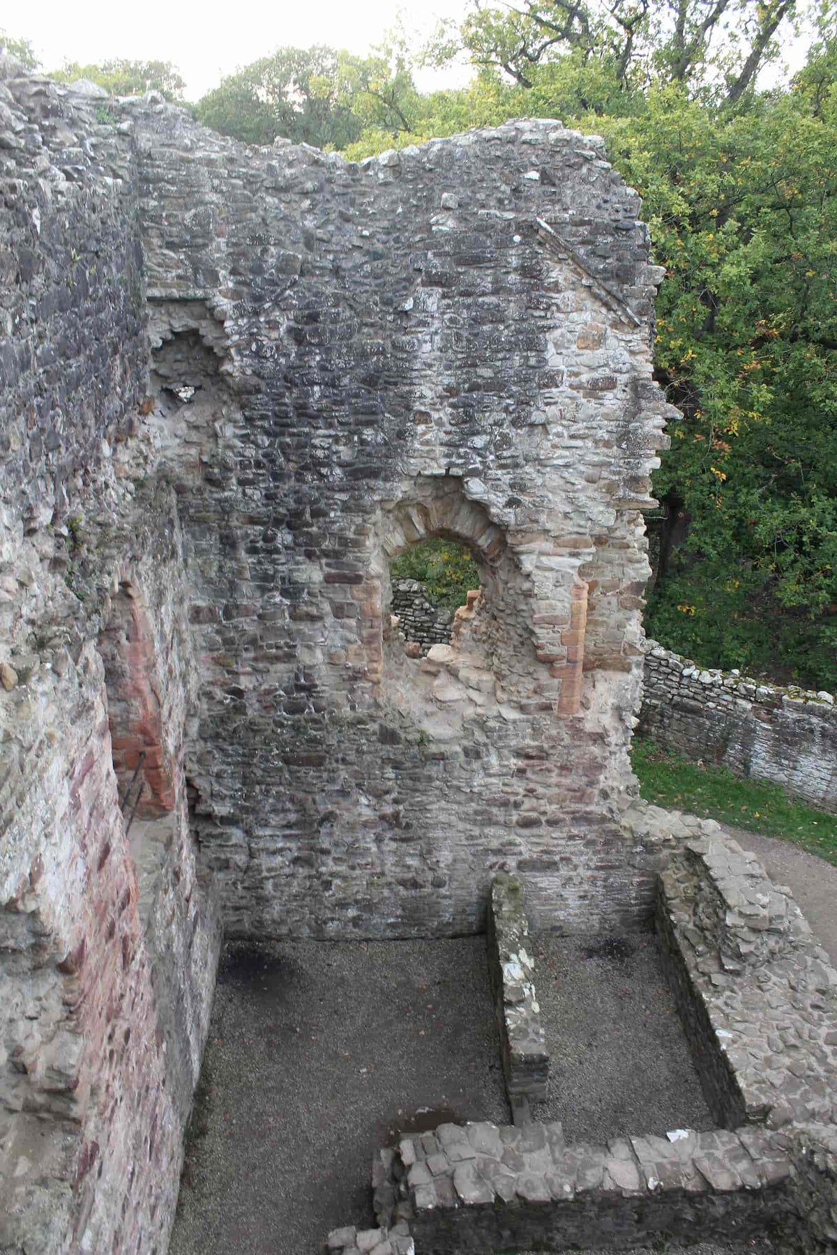 Inside the D-shaped Welsh Tower at Ewloe Castle seen from above, with a round-arched window, October 2026