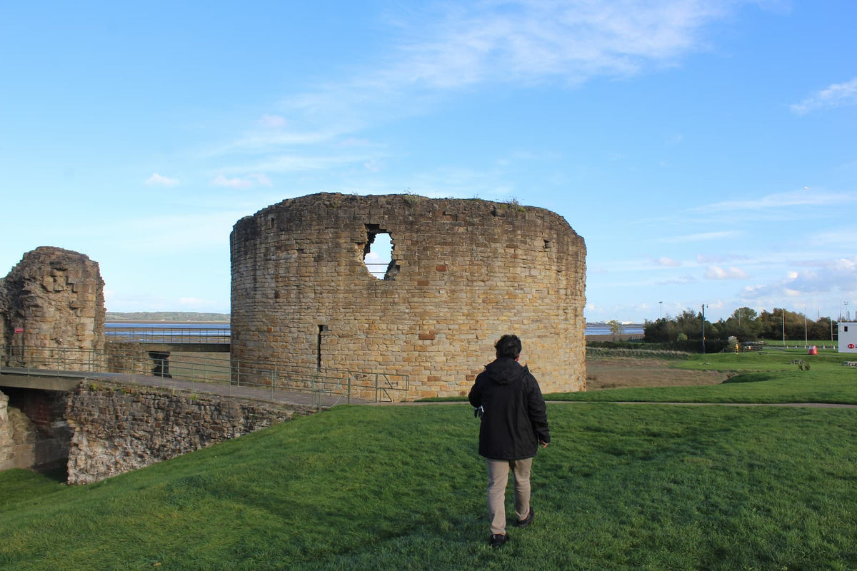 The great tower of Flint Castle and the bridge across its moat, with the Dee Estuary beyond, October 2026