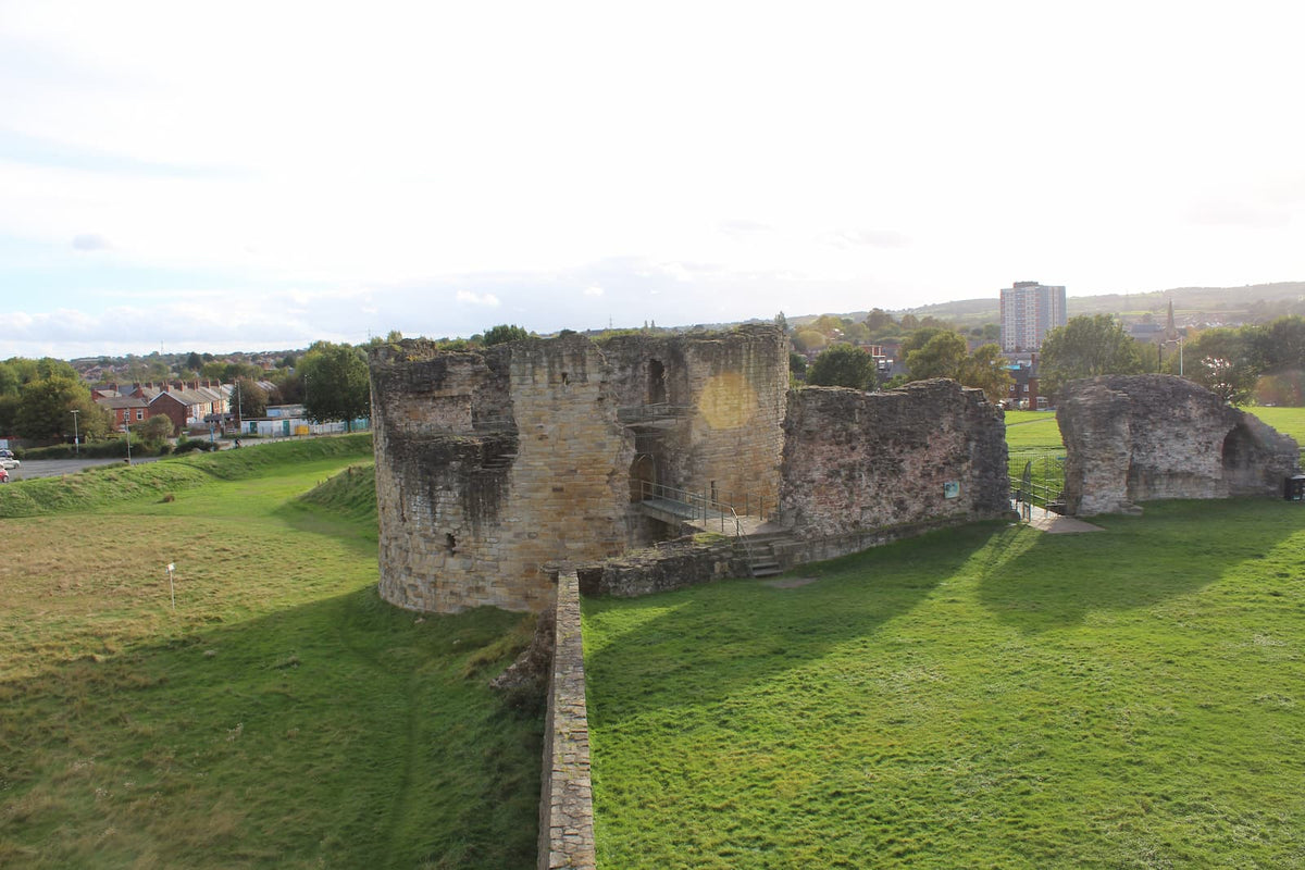 Looking down into the grassy inner ward of Flint Castle from the north-east tower, October 2026