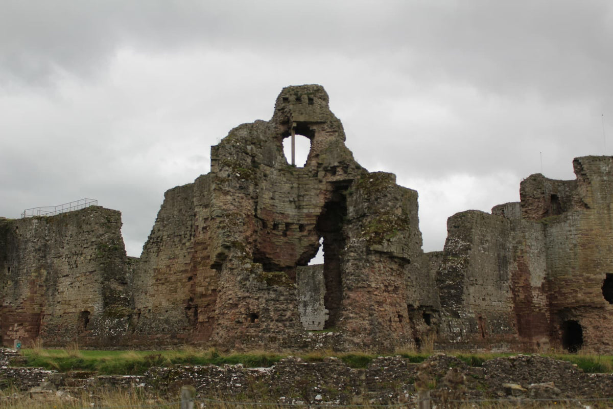 Ruined gatehouse and inner ward walls of Rhuddlan Castle in red sandstone