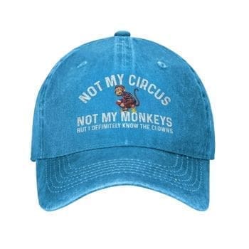 The Not My Circus Not My Monkeys But I Definitely Know The Clowns Cap is blue and features the phrase NOT MY CIRCUS NOT MY MONKEYS BUT I DEFINITELY KNOW THE CLOWNS with a playful monkey illustration above the text.