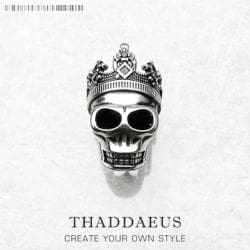A Skull Crown Pendant with an ornate crown is centered on a white background. Below, the text reads THADDAEUS and CREATE YOUR OWN STYLE.