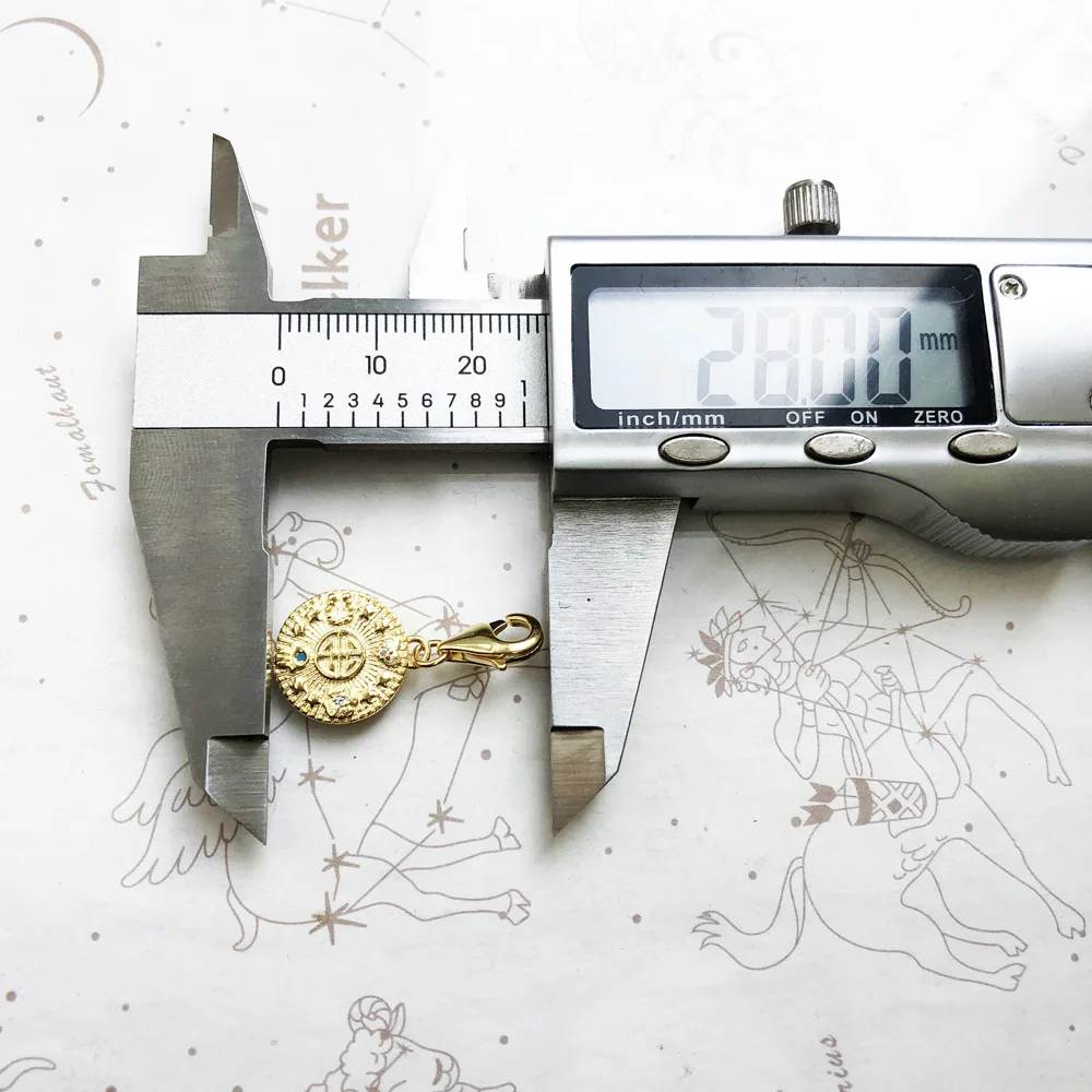 The Golden Lucky Coin Charm for Women, made of 925 sterling silver with a vintage pendant design, features engraved patterns, a central symbol, gemstones, and a lobster clasp.