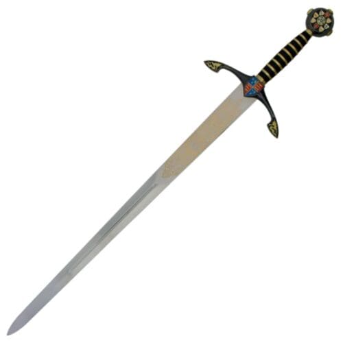 The Replica Black Prince Sword features a straight, polished steel blade, an ornate gold and black hilt, and a round pommel with floral design and crest. Its guard displays detailed gold patterns for an authentic mediaeval appearance.
